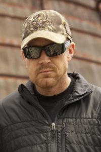 A man wearing sunglasses and a hat.