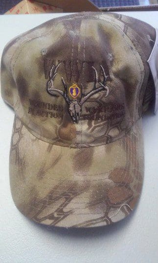 A camouflage hat with a deer on it