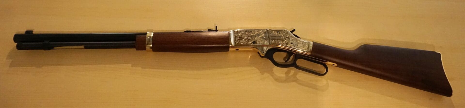 A wooden gun is displayed on a wall