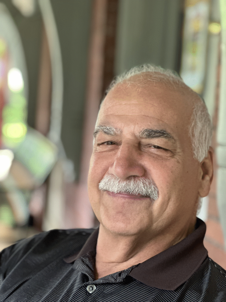Smiling man with a mustache indoors
