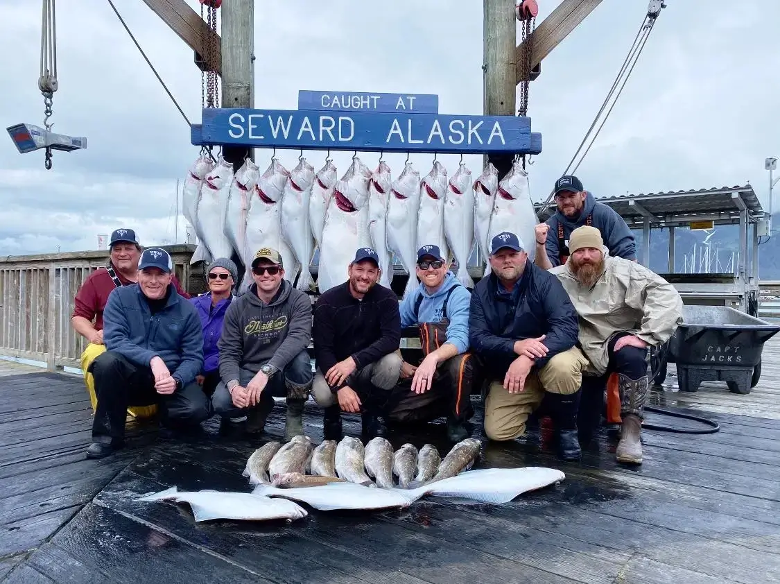 Group displaying caught fish in Seward Alaska