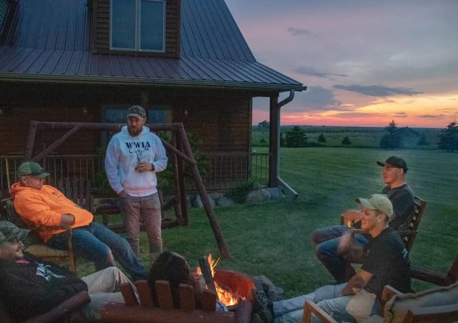 Group relaxing by fire at sunset Wounded Warriors in Action Foundation Group relaxing by fire at sunset