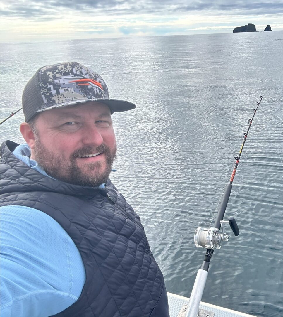 Man fishing on a boat at sea.