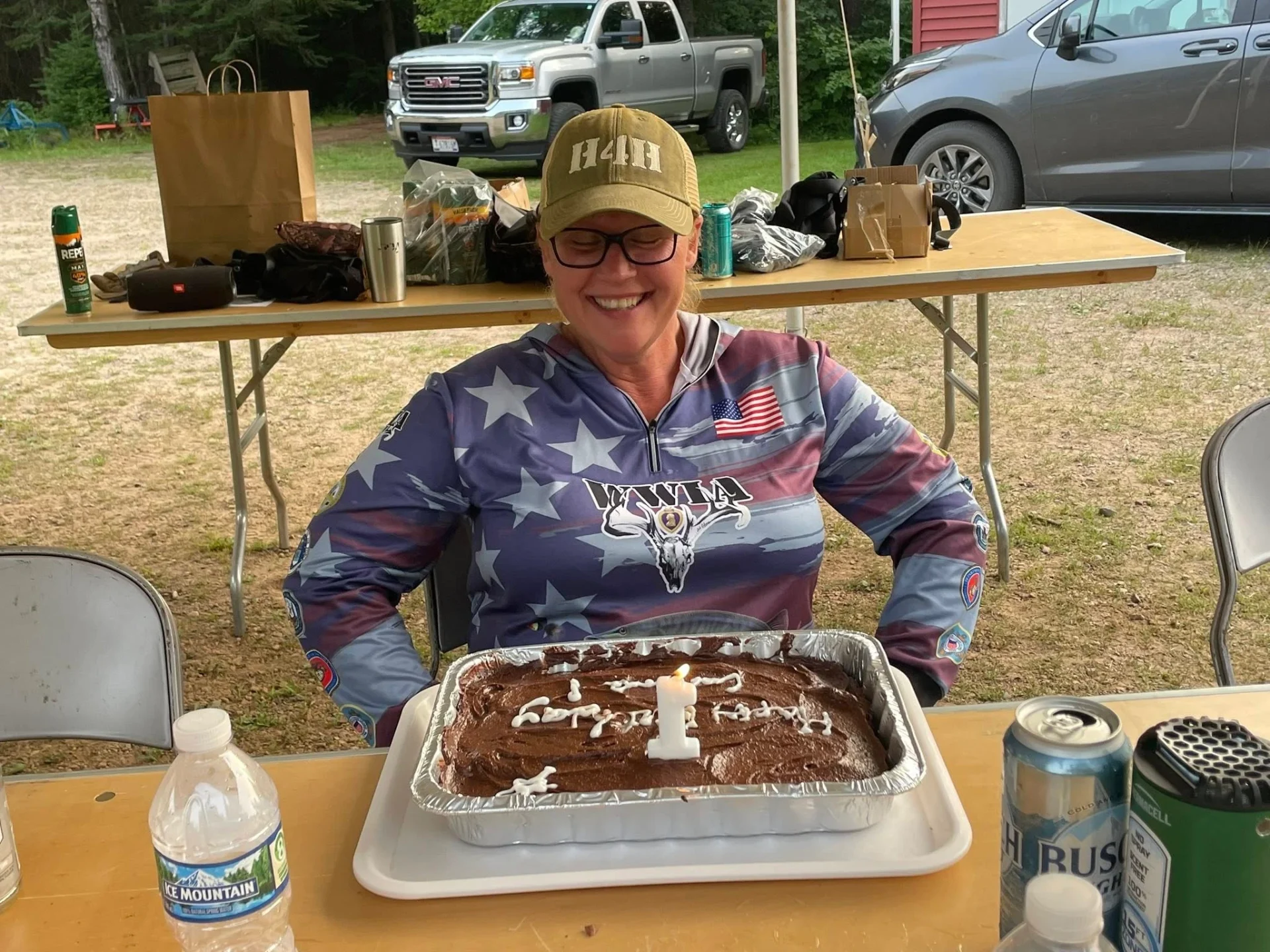 Woman smiling with birthday cake outdoors