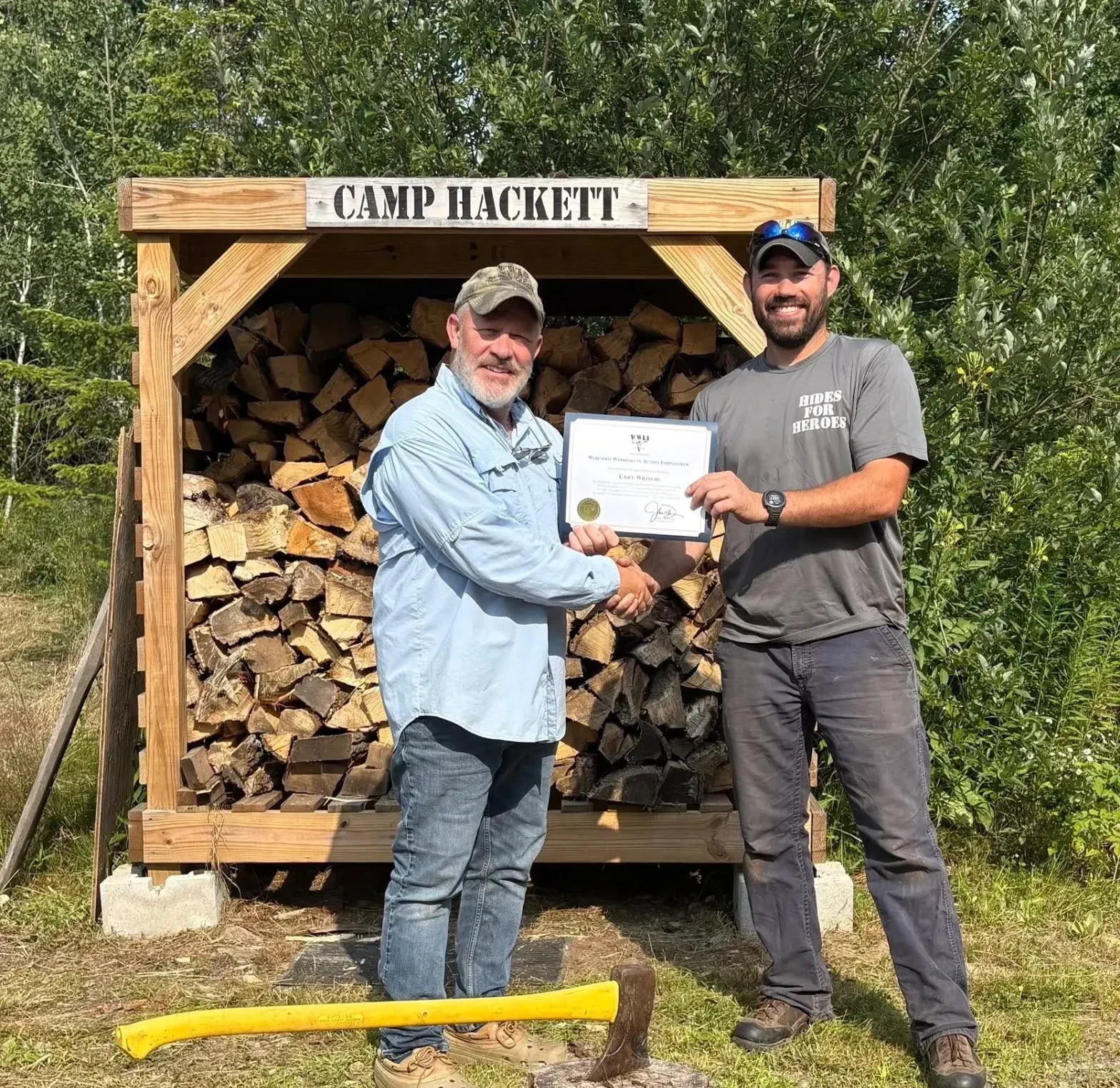 Certificate presentation at Camp Hackett woodpile