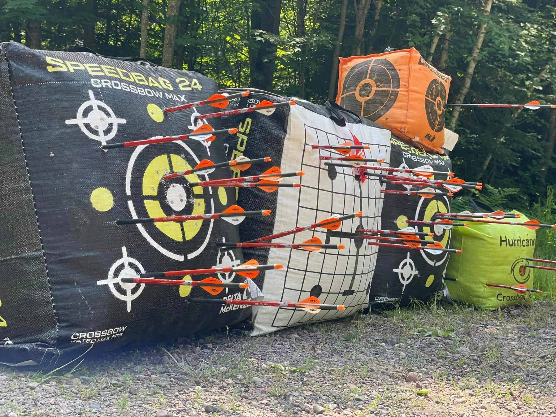 Orange fletched arrows stuck in foam targets
