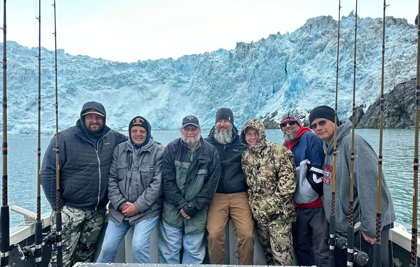 Group fishing trip in front of glacier