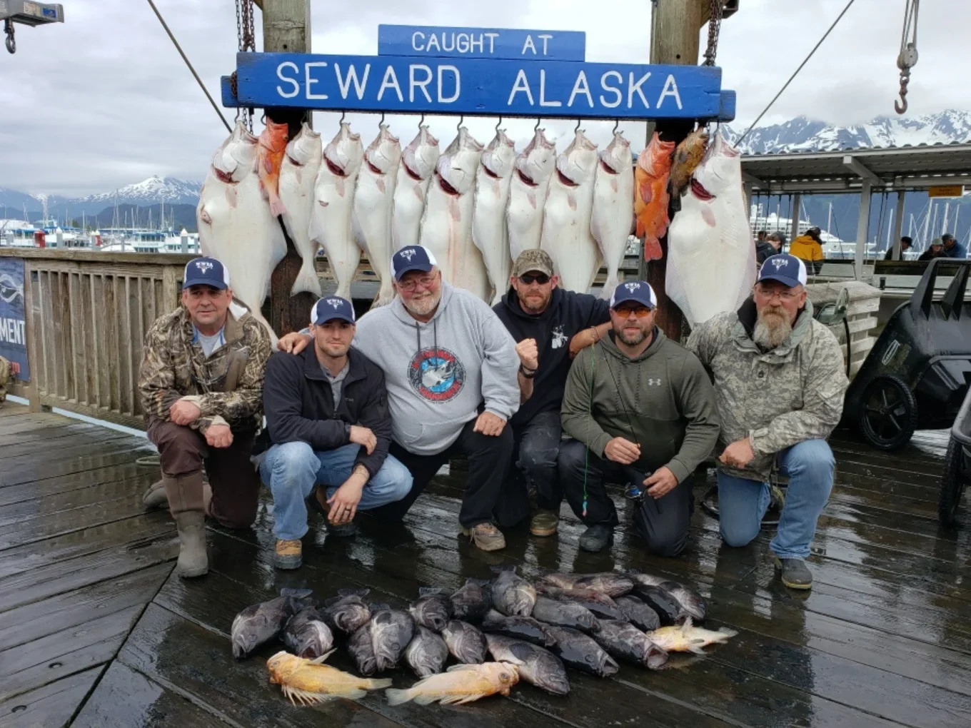 Group of men with caught fish display Wounded Warriors in Action Foundation Group of men with caught fish display