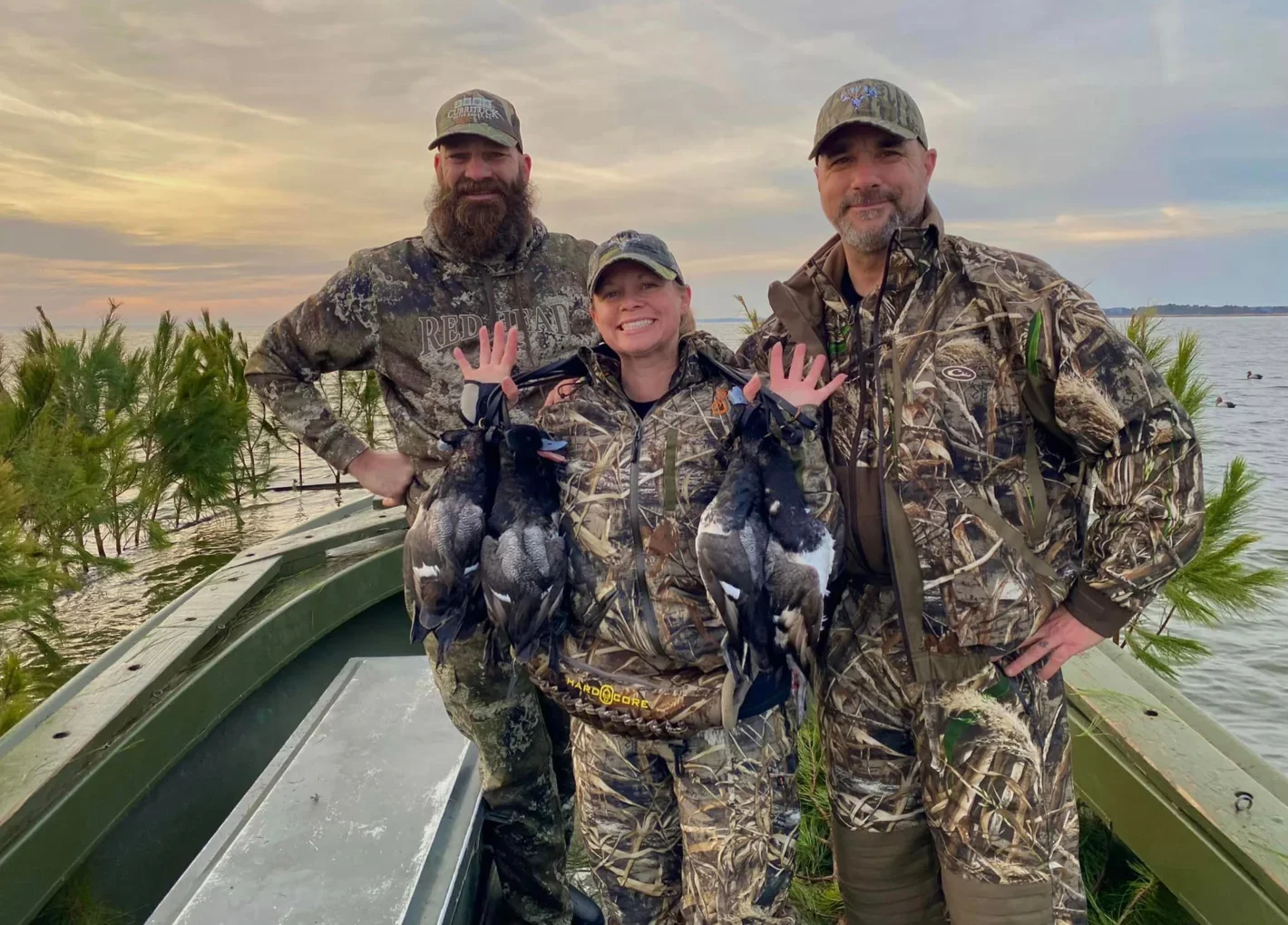 Three hunters with ducks on a boat Wounded Warriors in Action Foundation Three hunters with ducks on a boat