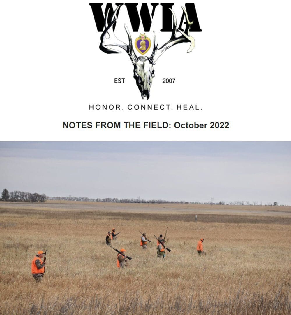 Hunters walking through an open field