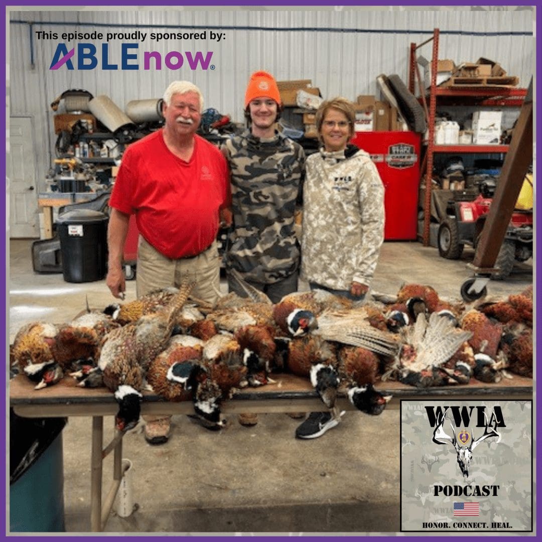 Three people with a table of pheasants