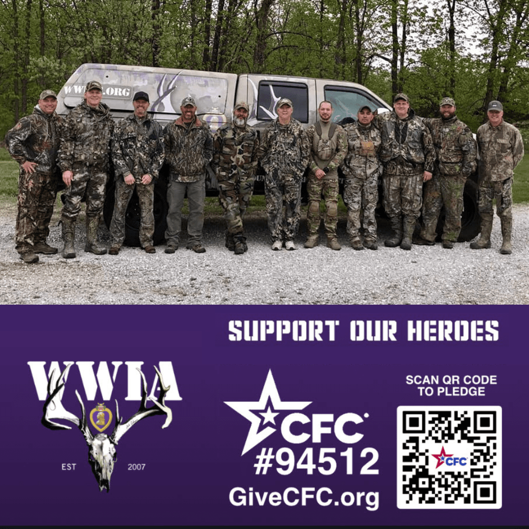 Group in camouflage gear in front of vehicle