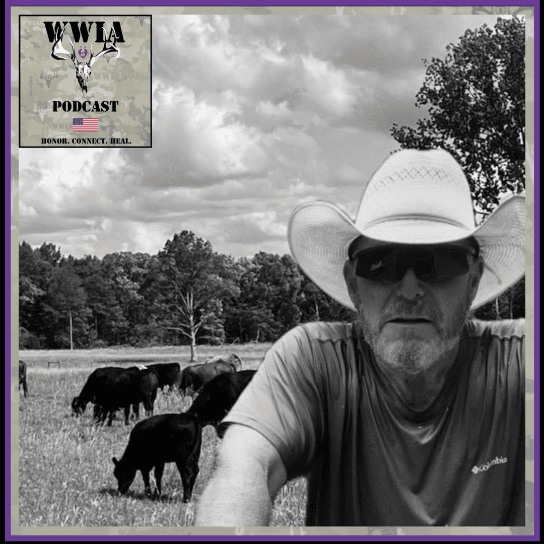 Man in cowboy hat with grazing cattle