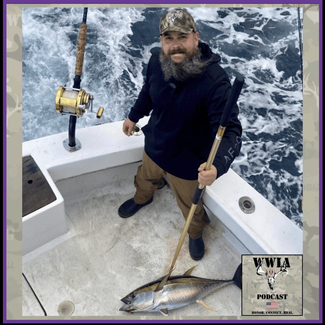 Man with fishing rod and tuna on boat