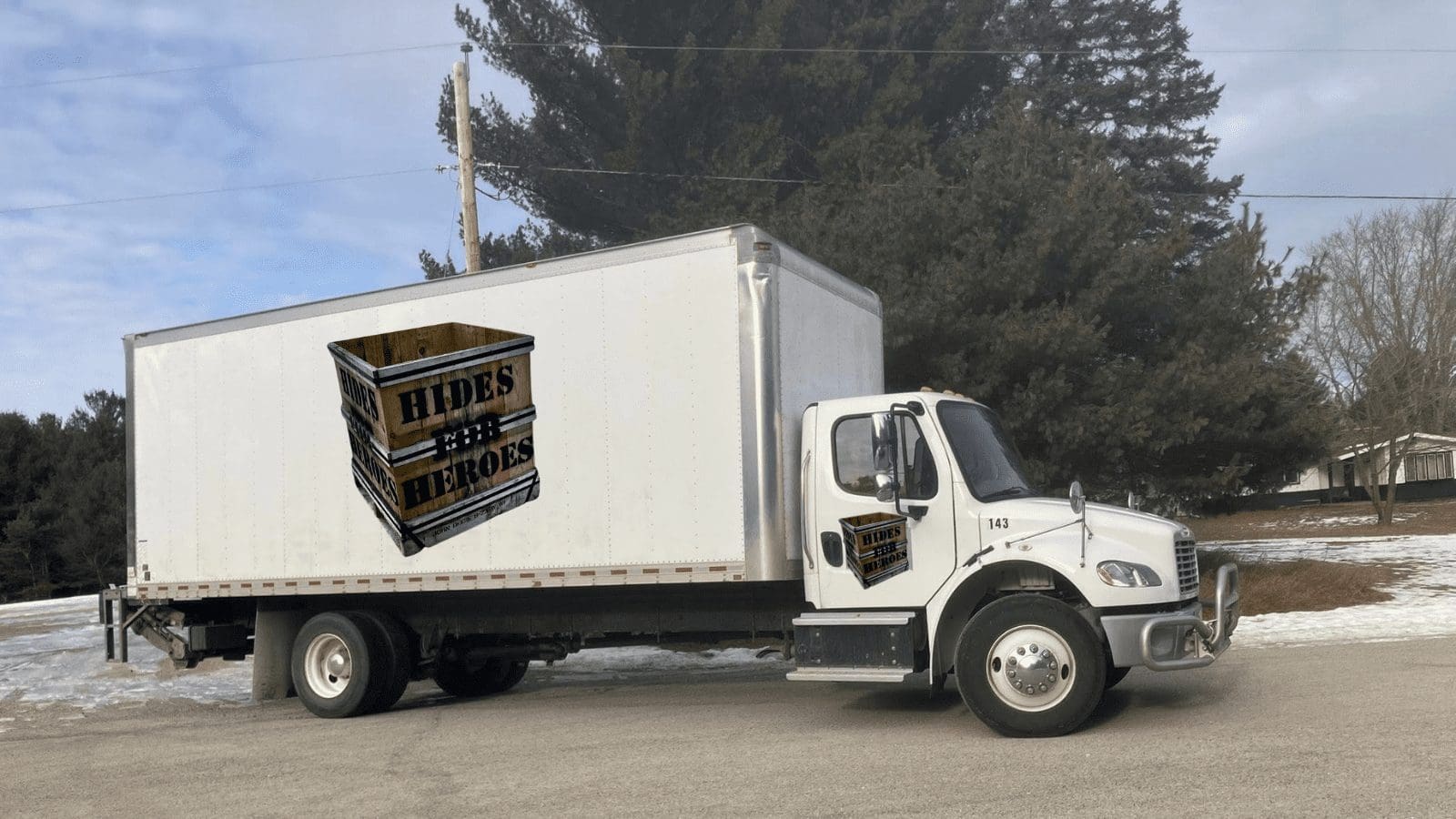 White delivery truck with Hides for Heroes logo