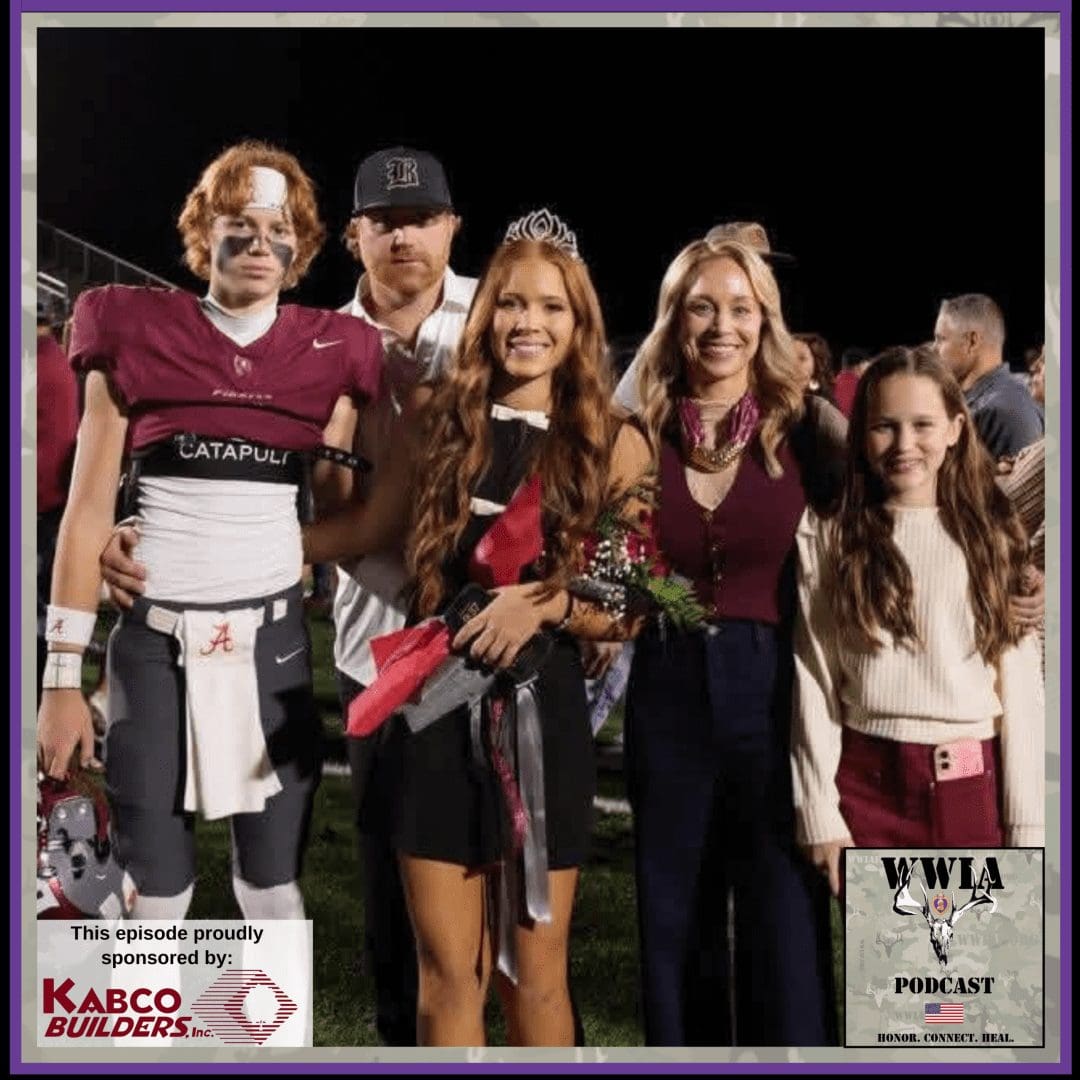 Family celebrating on a football field at night