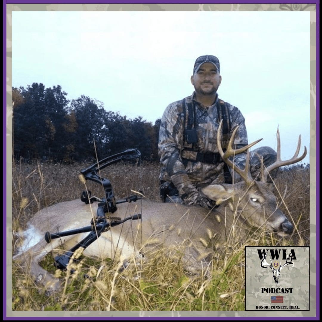 Hunter posing with a large harvested deer